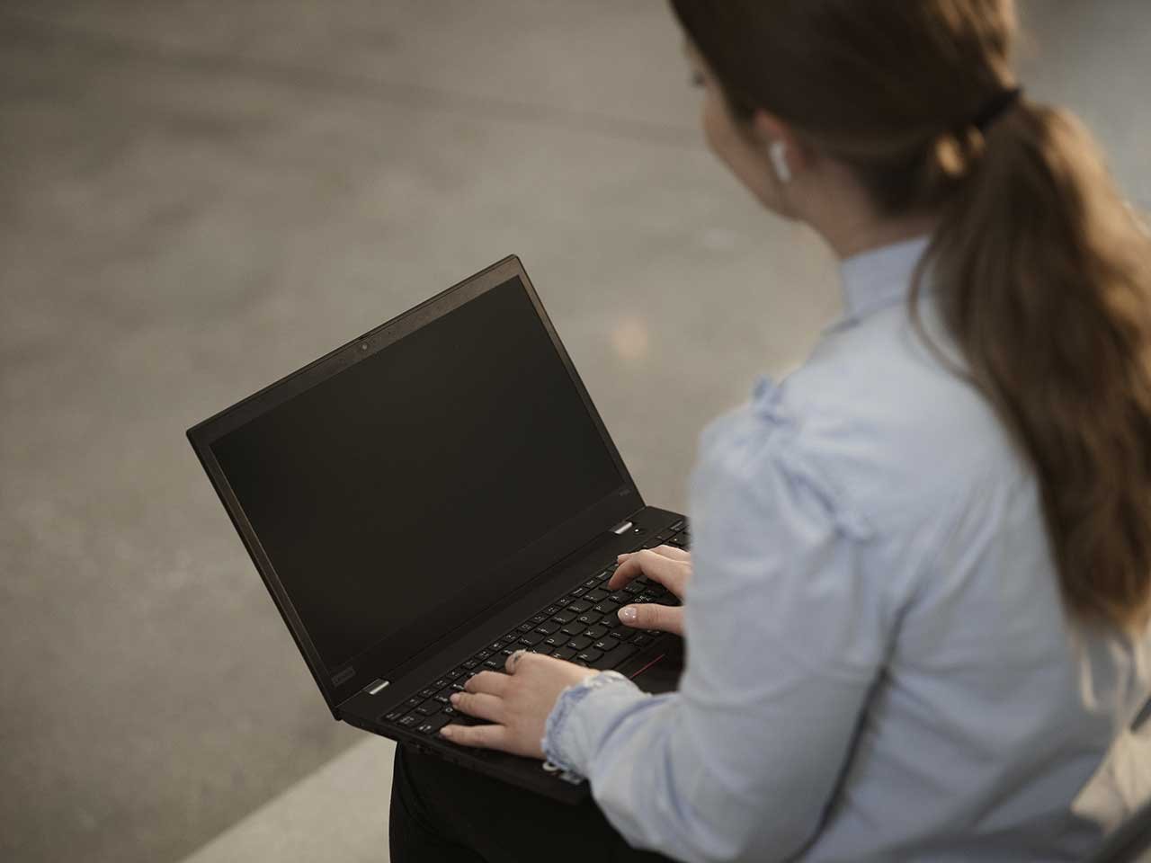 Person sitting with a laptop